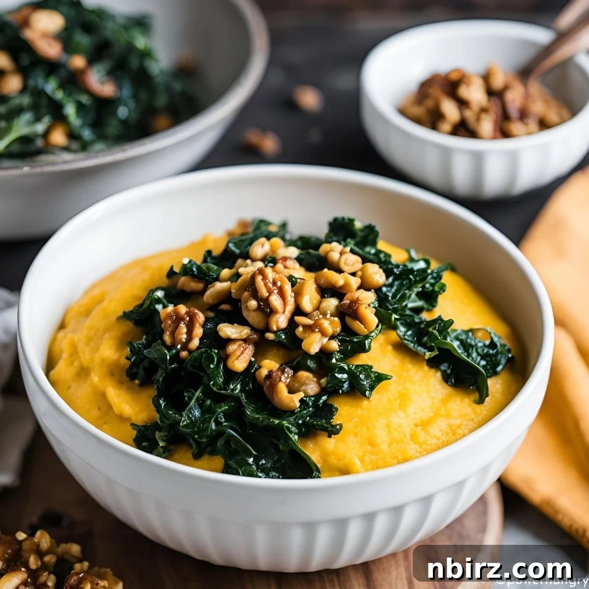 Creamy Pumpkin Polenta Power Bowl with Kale 2 Creamy pumpkin polenta with vibrant green sautéed kale served in a white bowl on a wooden cutting board