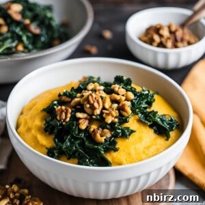 A top-down view of pumpkin polenta with a generous topping of sautéed kale and chopped nuts in a white bowl.