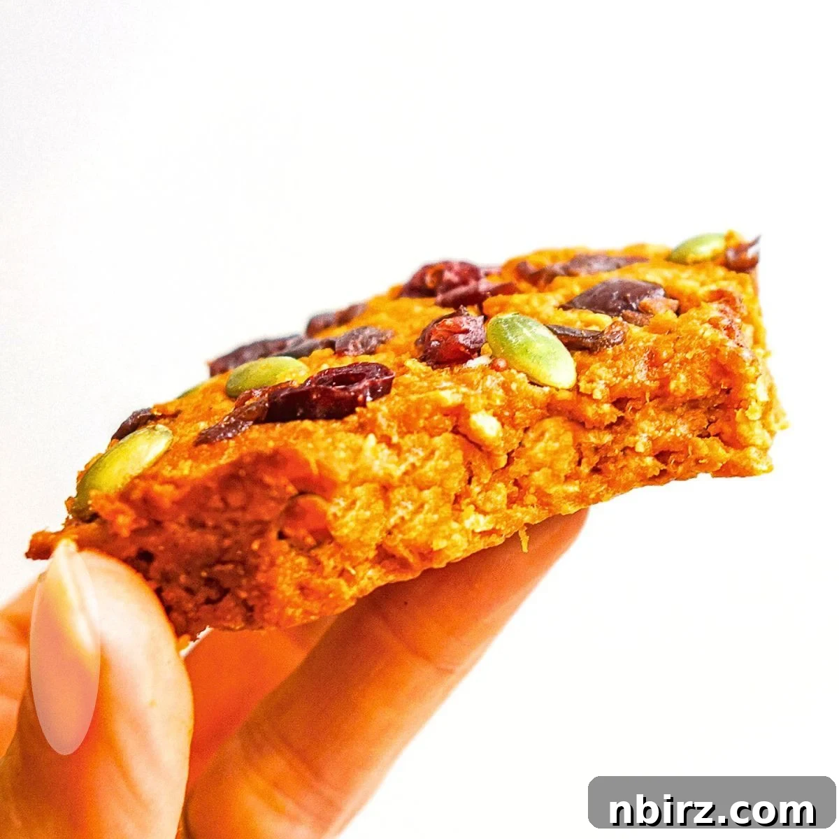TVP Pumpkin Protein Bars: A Naturally Boosted Treat 11 Handheld TVP bar with a bite taken out