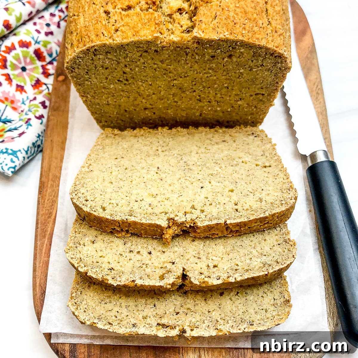 High-Protein Chickpea Bread 11 Sliced chickpea flour protein bread on a wooden cutting board