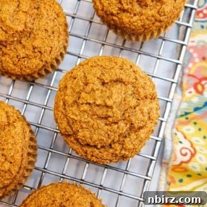 Overhead shot applesauce oat flour muffins on cooling rack