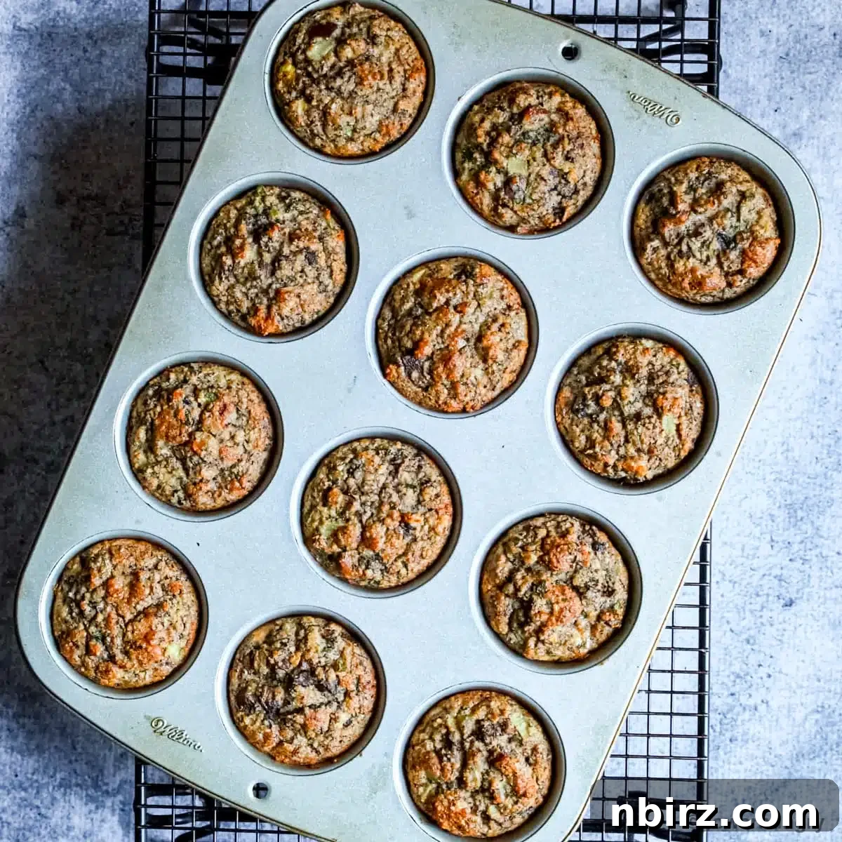 Savory High-Protein Vegan Mushroom Muffins with Almond Flour 2 vegan almond flour muffins in a muffin tin on a cooling rack