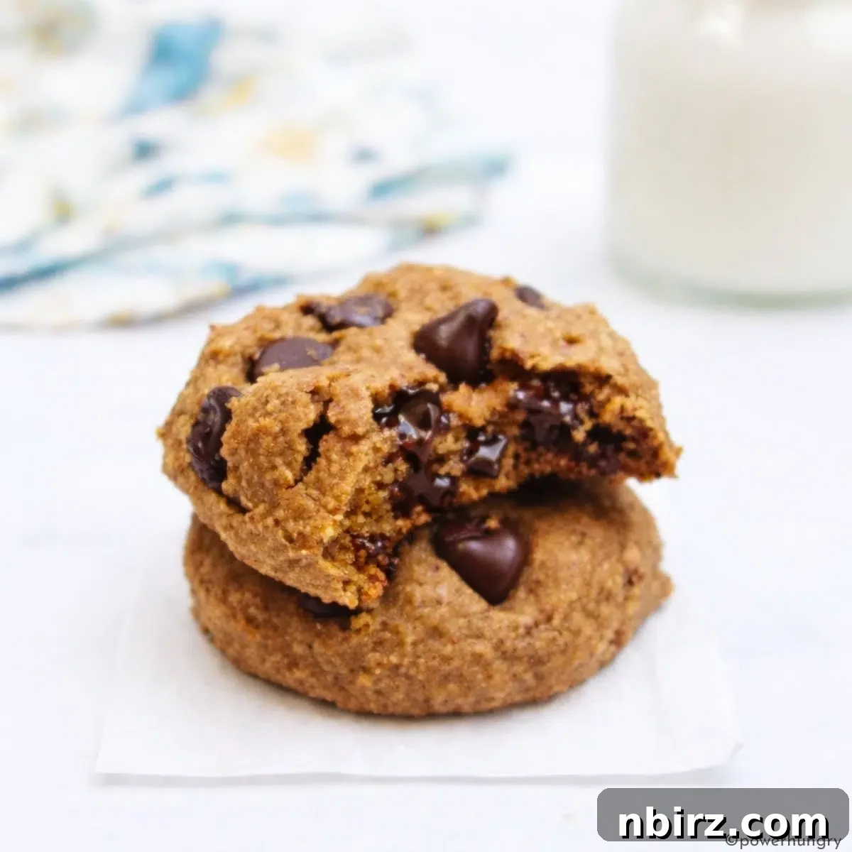 Stack of vegan oat flour chocolate chip cookies, showcasing their soft texture and golden-brown edges.