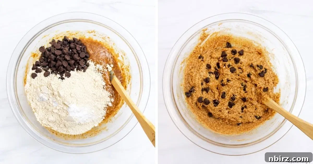 Mixing bowl showing dry ingredients and chocolate chips being folded into the wet ingredients to form thick cookie dough.