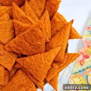 Close-up of high-protein nacho cheese lentil chips in a white bowl