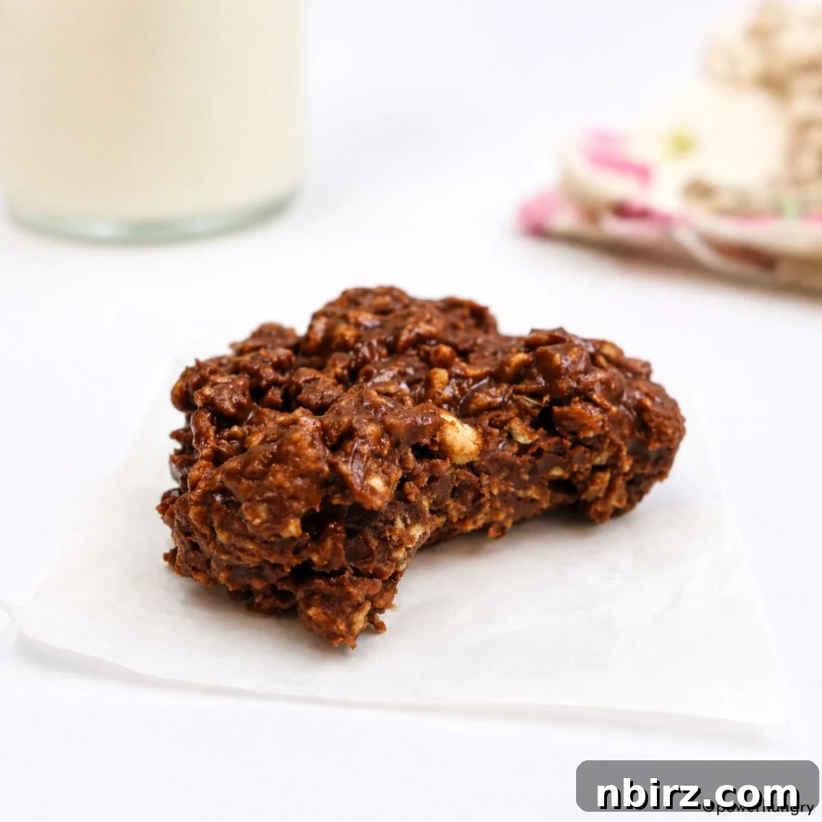 a single chocolate no-bake protein cookie on a piece of parchment paper