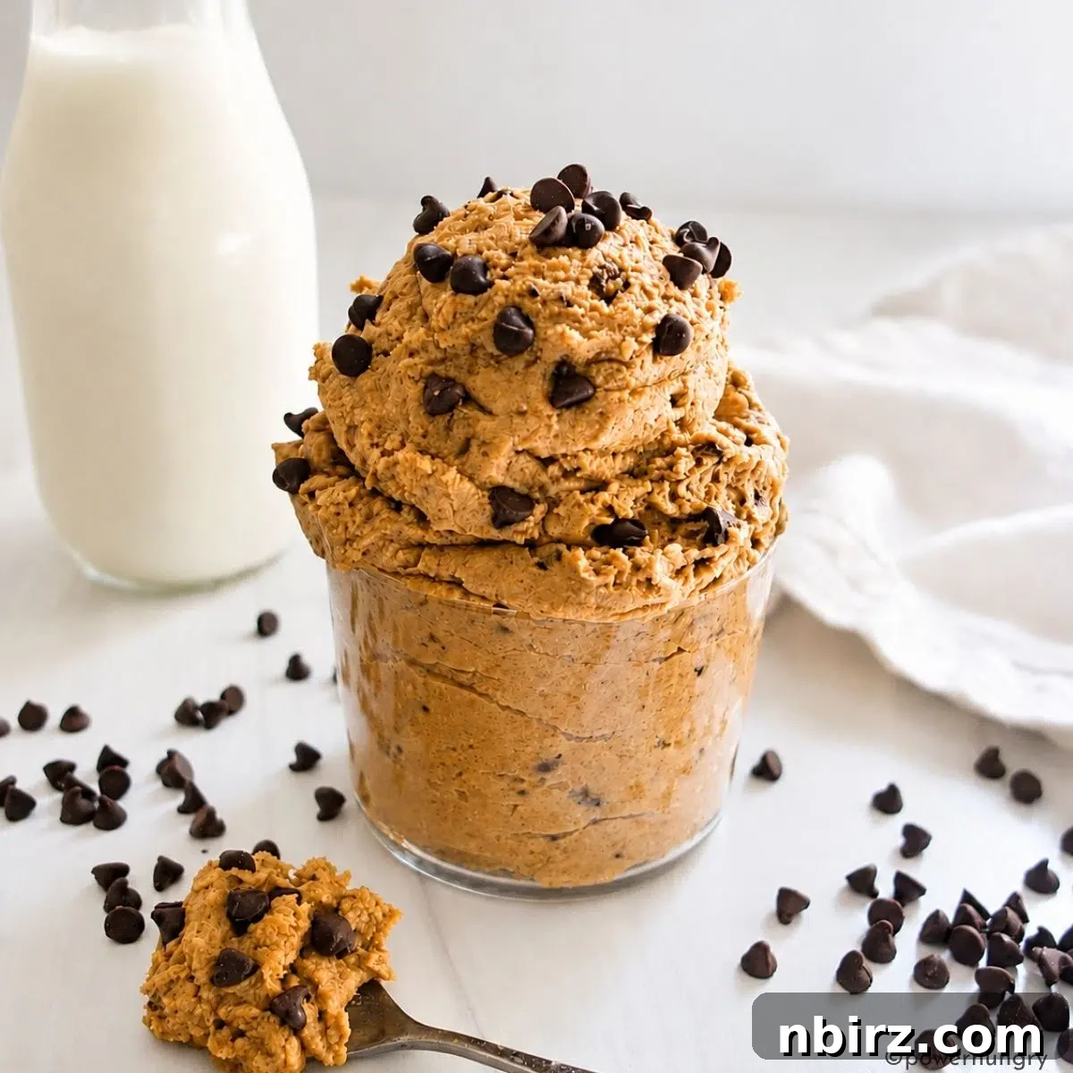 Protein-Packed Lentil Cookie Dough Recipe 8 high protein cookie dough with a spoonful of dough and a container of milk nearby